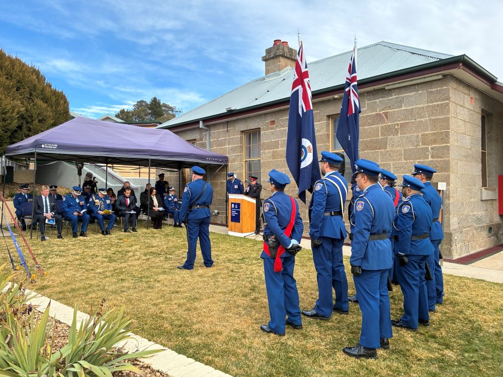 Staff saluting the seated dignitaries