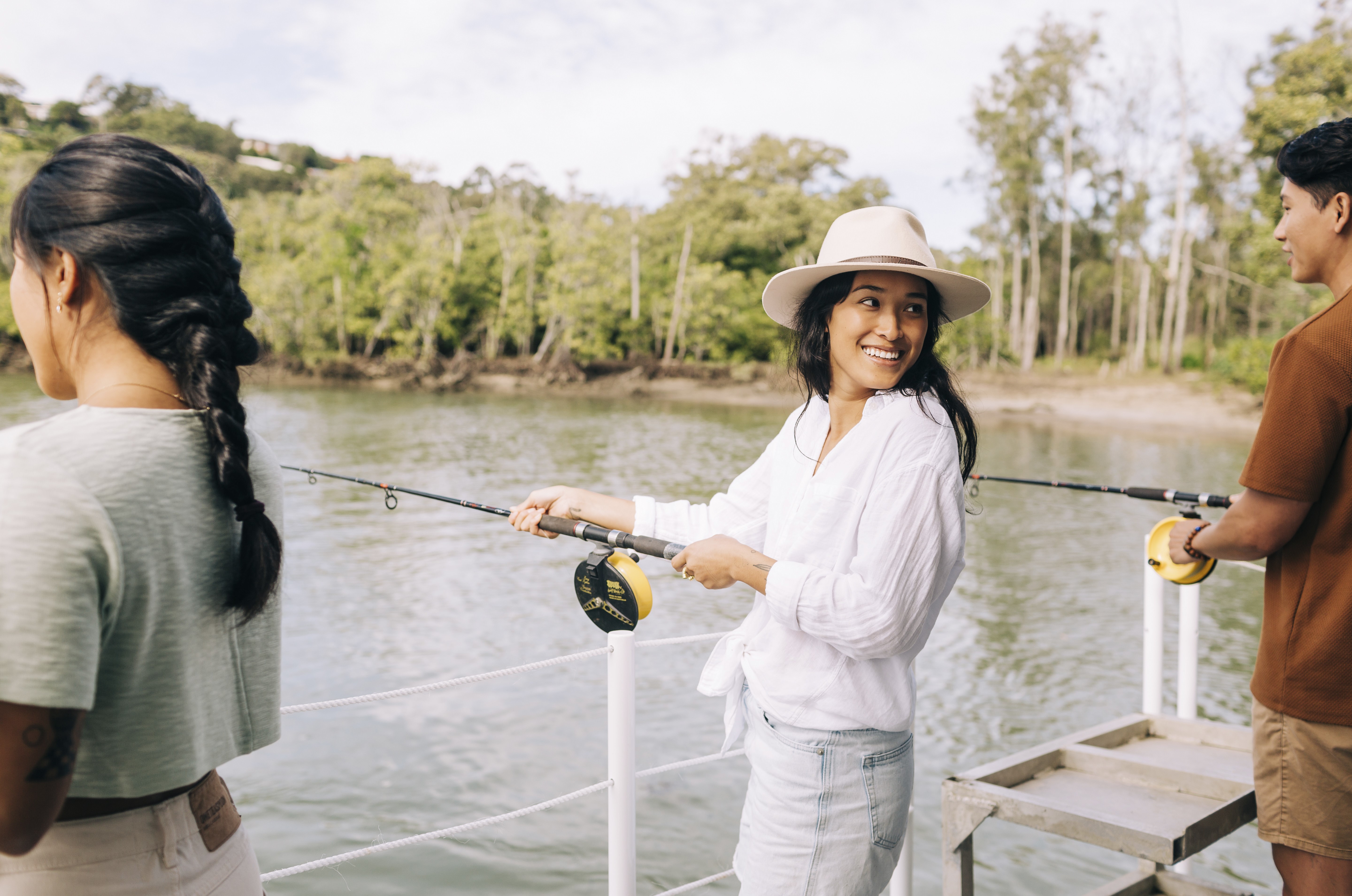 A photo of a woman fishing on a boat on a river