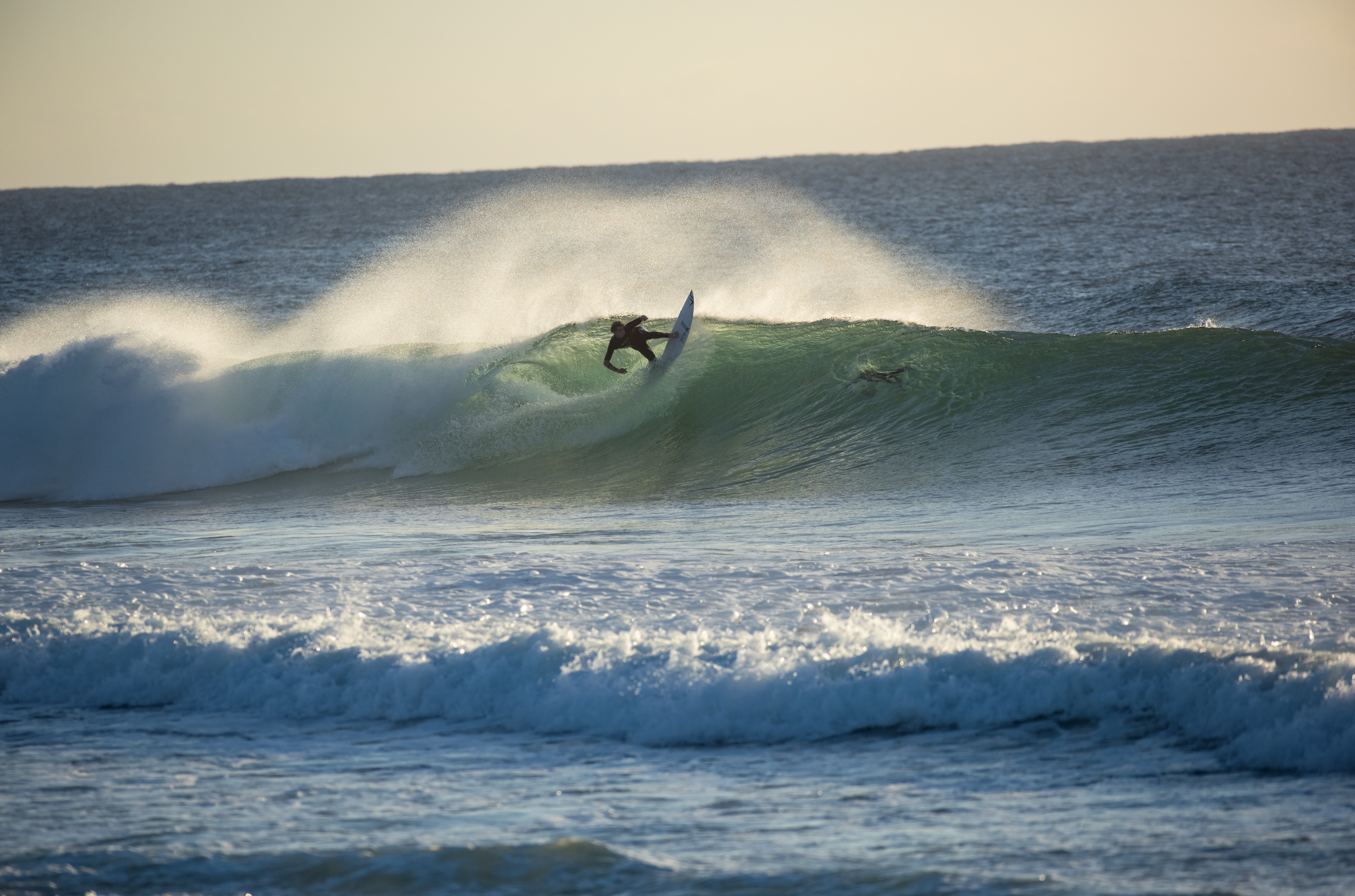 A surfer catching a wave at Duranbah Beach in Tweed Heads