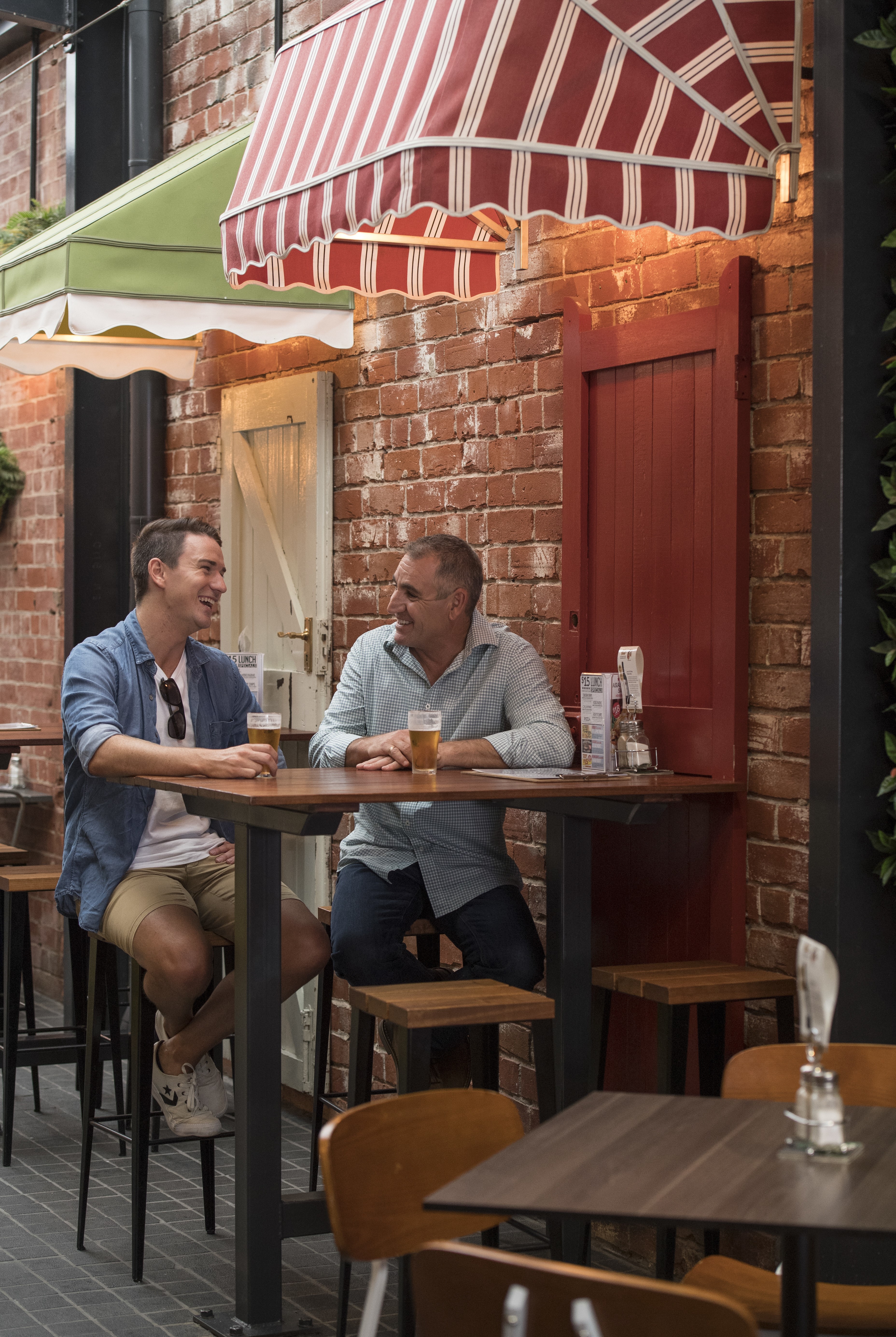 A photo of two friends drinking at the Bended Elbow