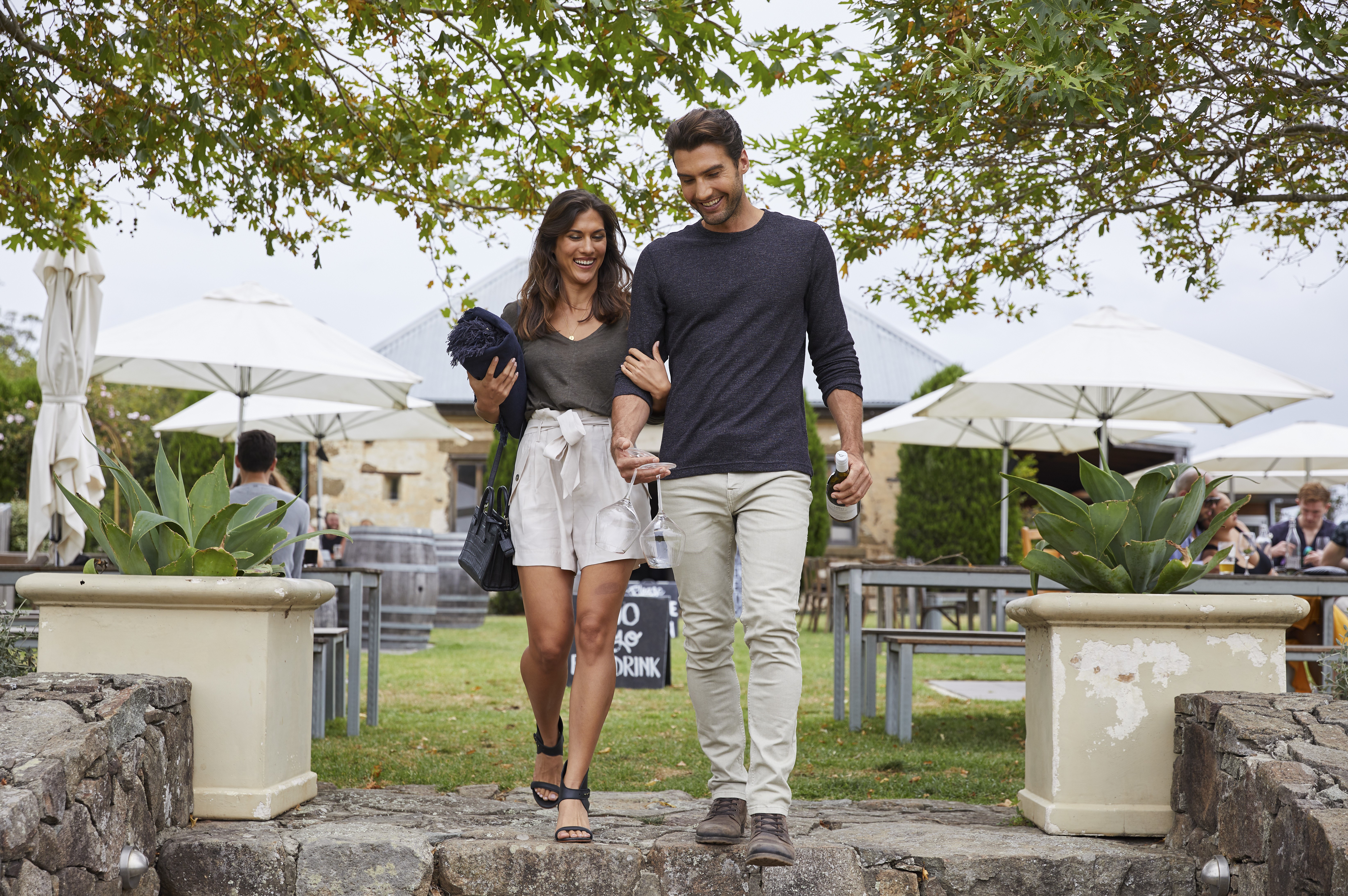A photo of a couple walking through Cupitt's Winery