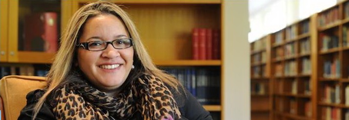 Portrait of Professor Megan Davis sitting in a library