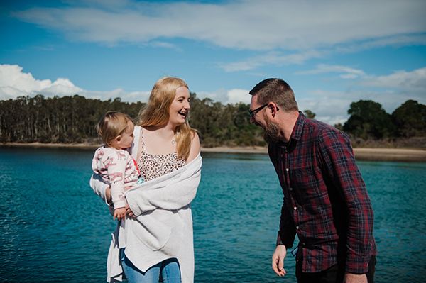 Picture of Ella holding Violet while caseworker James smiles at them