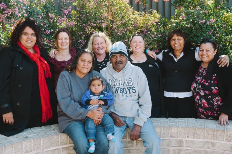 A happy family at the family planning circle with FACS workers