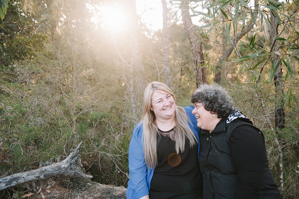 Two women smiling and hugging