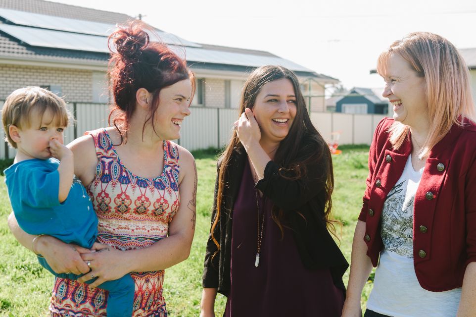 Amelia and her case workers talking and laughing 