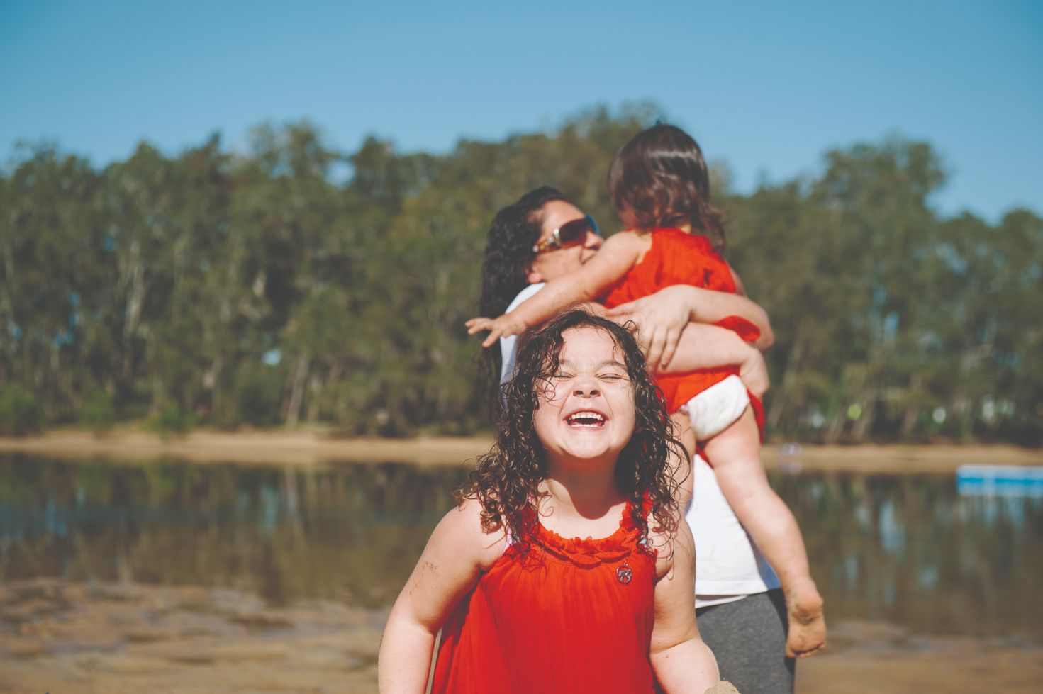 A picture of Alison and her two daughters playing