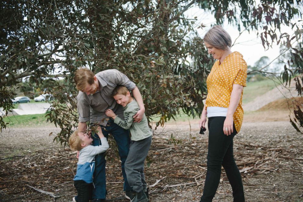 Jodie standing with Adam and his two sons