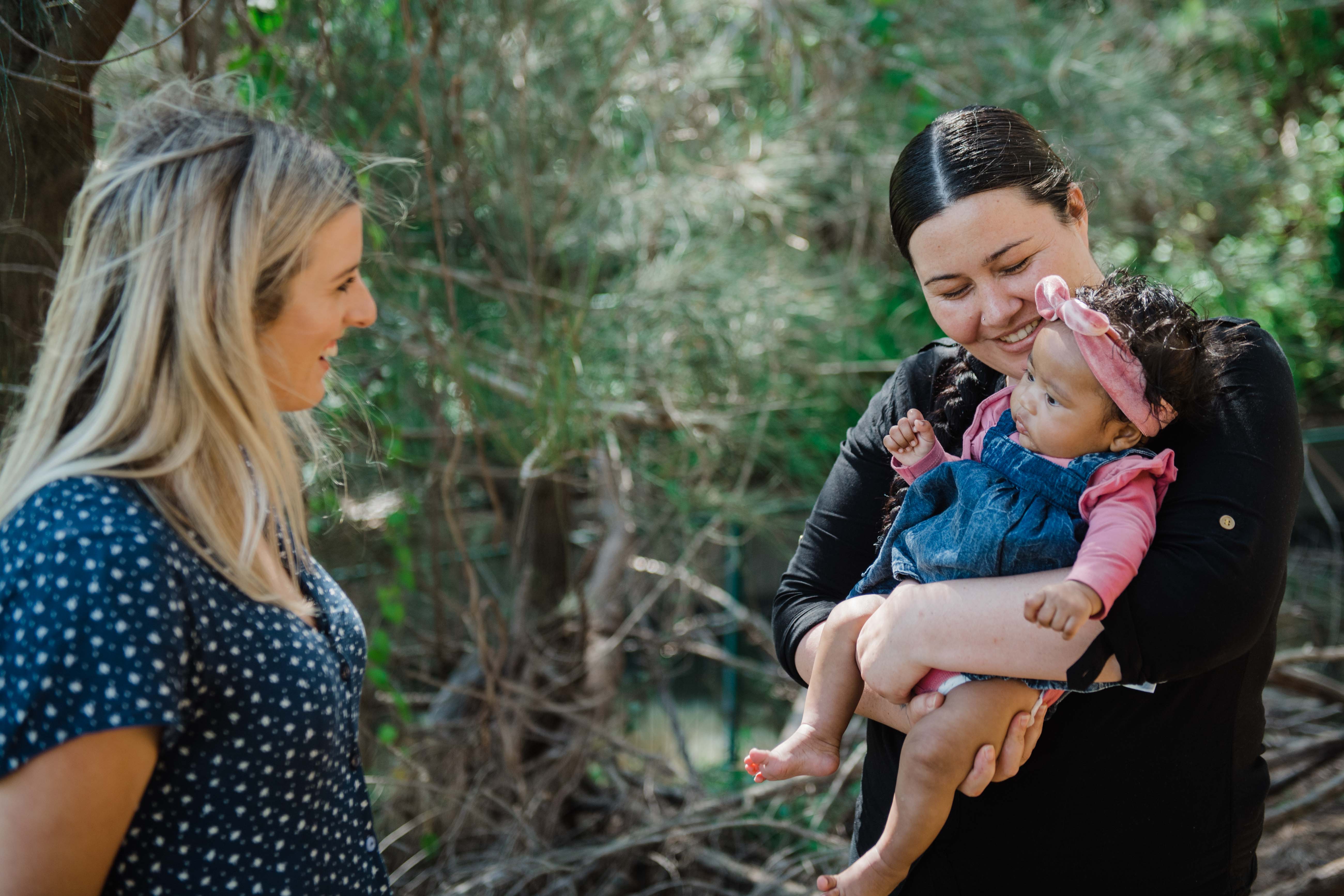 Caitlin, Aneeka and her baby all looking at each other