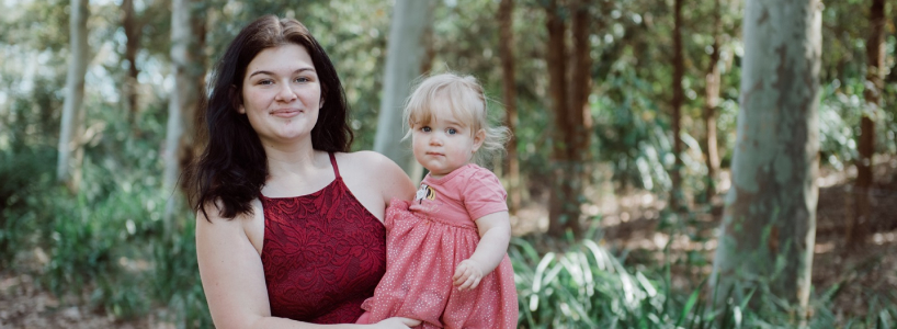 Photo of Elissia holding her daughter Ava and smiling