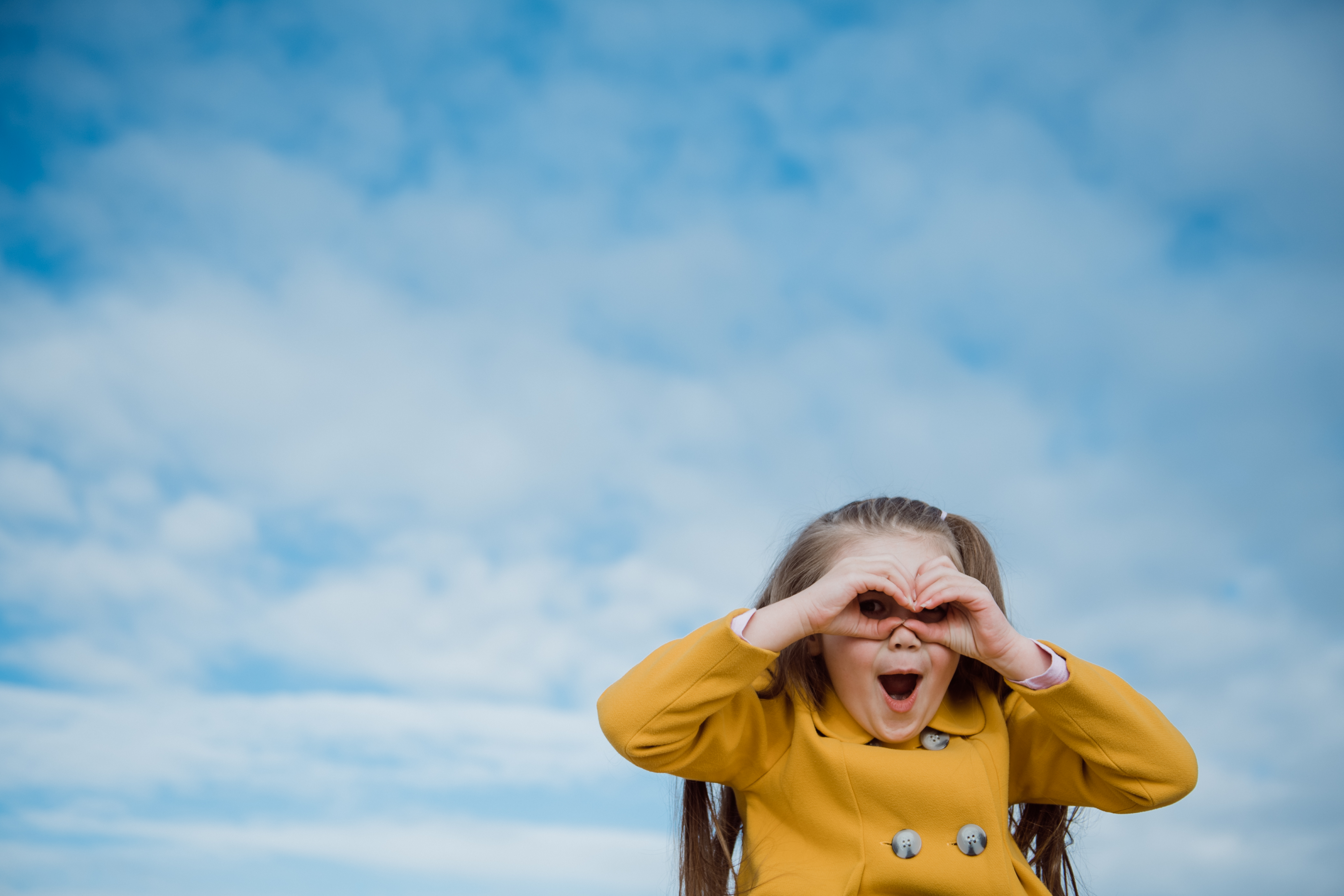 Photo of a child making eye binoculars