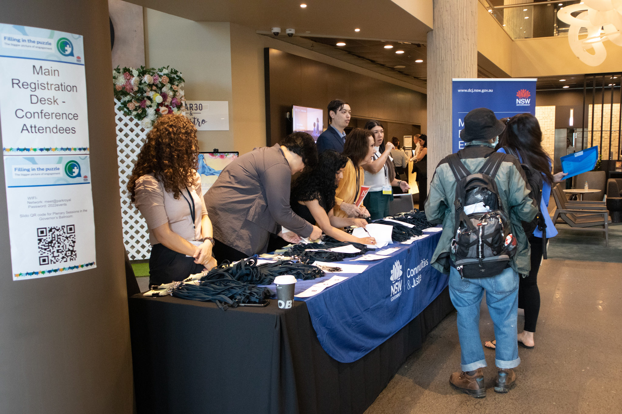 Conference guests being welcomed at the main conference registration table.