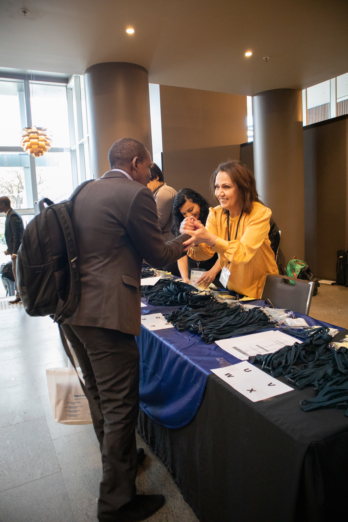 Three people at a registration desk