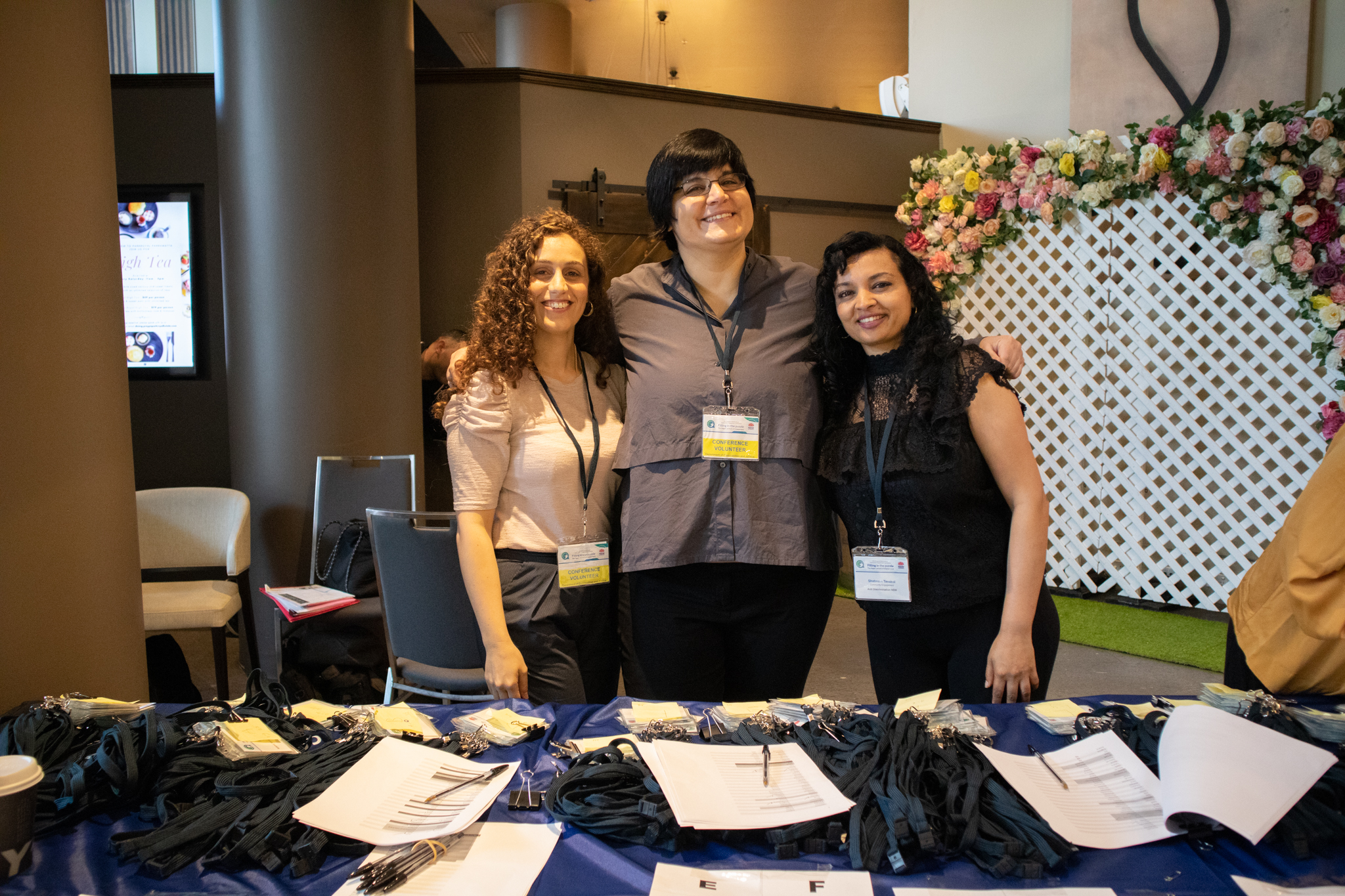 Three people at a registration desk