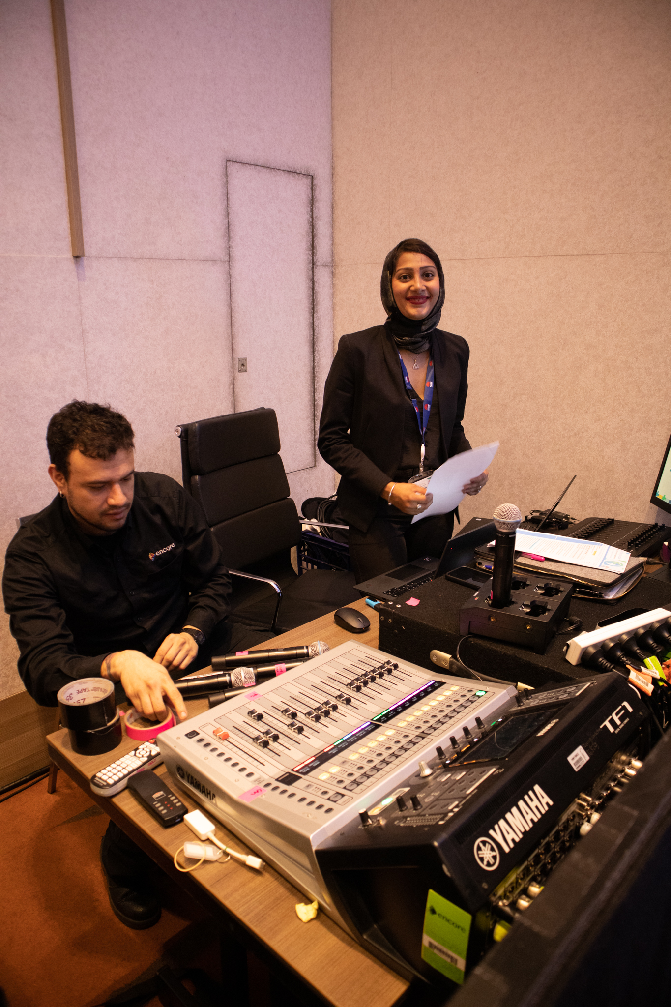 Two people at the IT control station in the ballroom