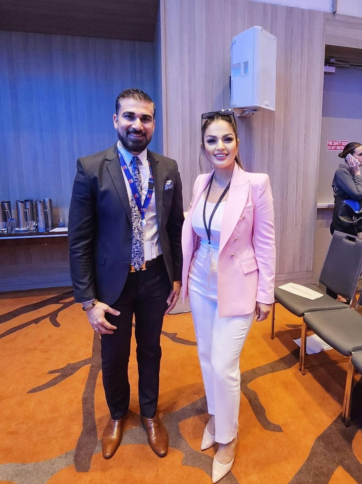 Two people standing and posing together