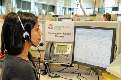 Woman with headset sitting at a computer